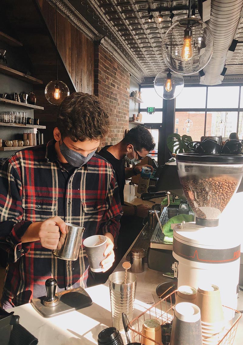 baristas making coffee drinks for customers