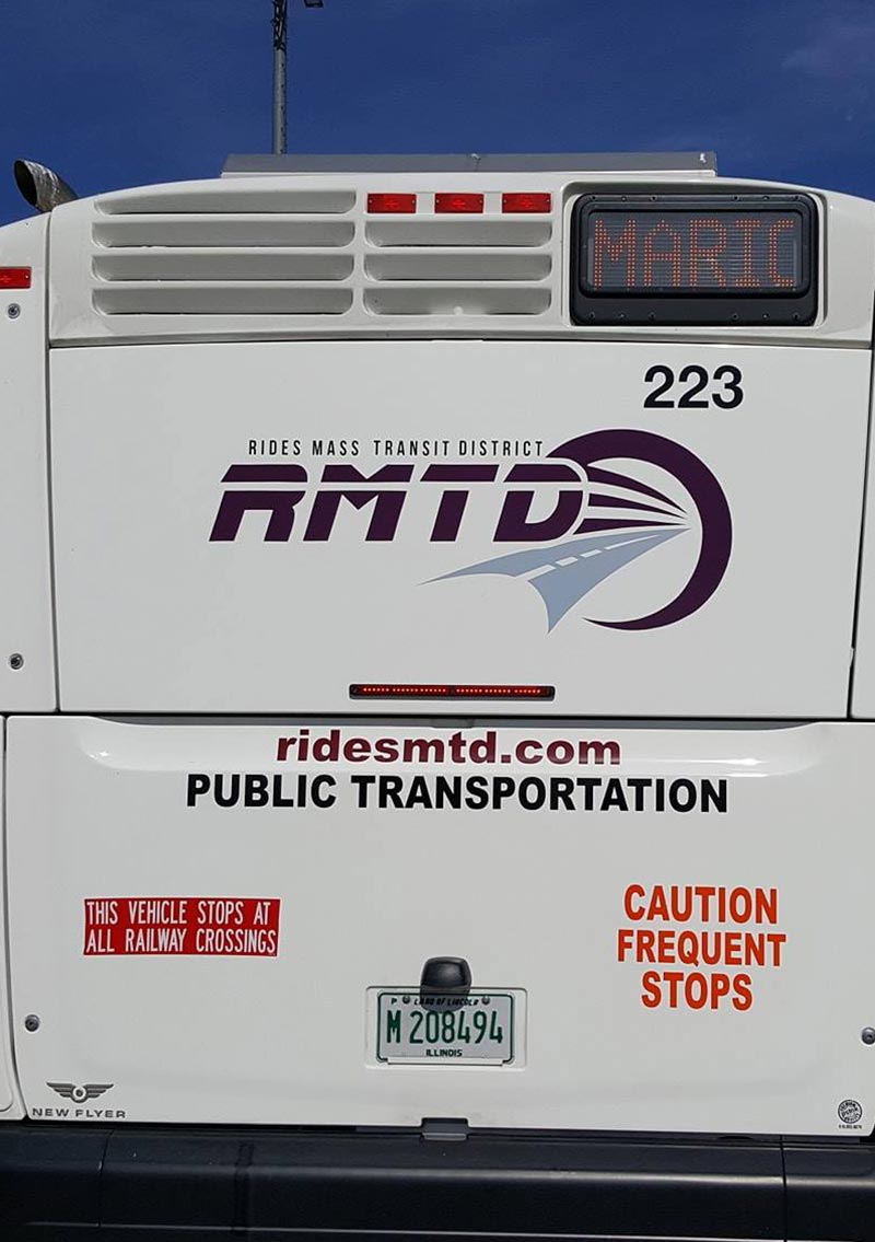 rear view of rides mass transit white bus with digital scroller sign