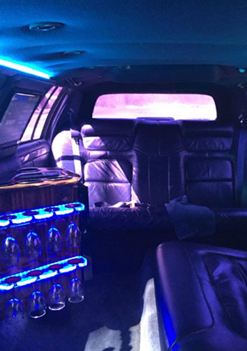 interior of limo with champagne glasses and neon lights