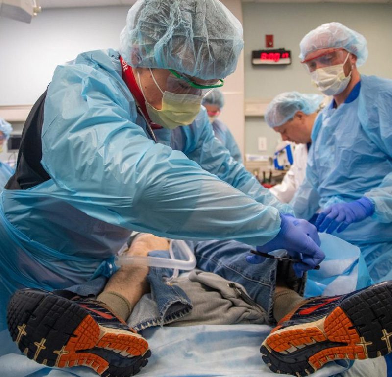 doctors cutting pants off of patient