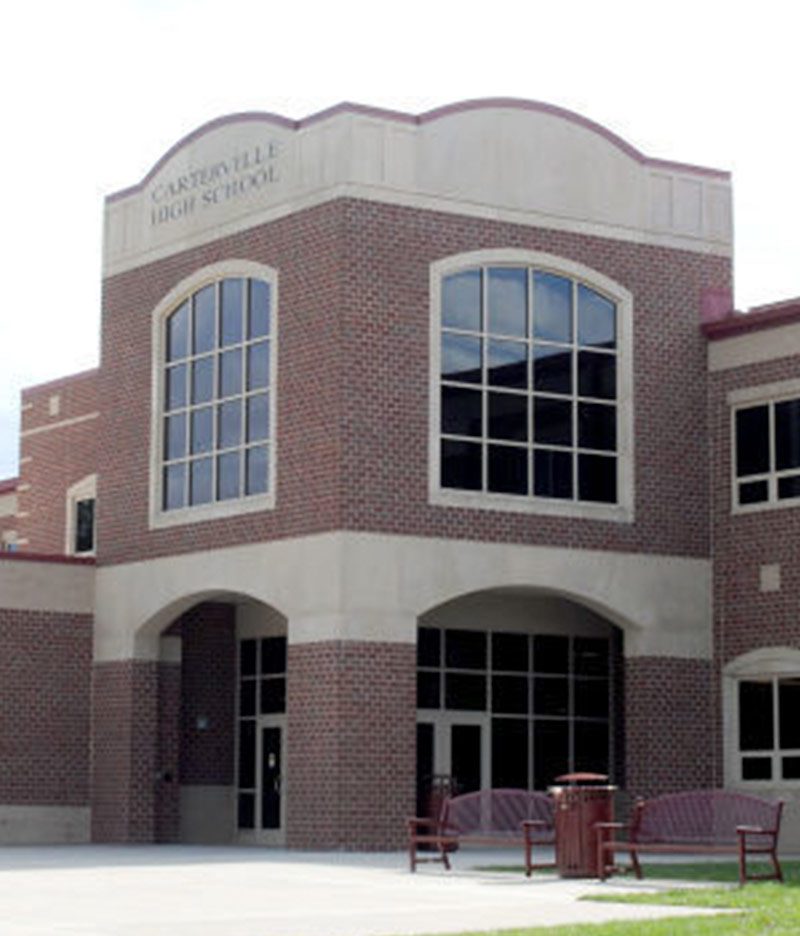 brick exterior of carterville high school with large windows on sides