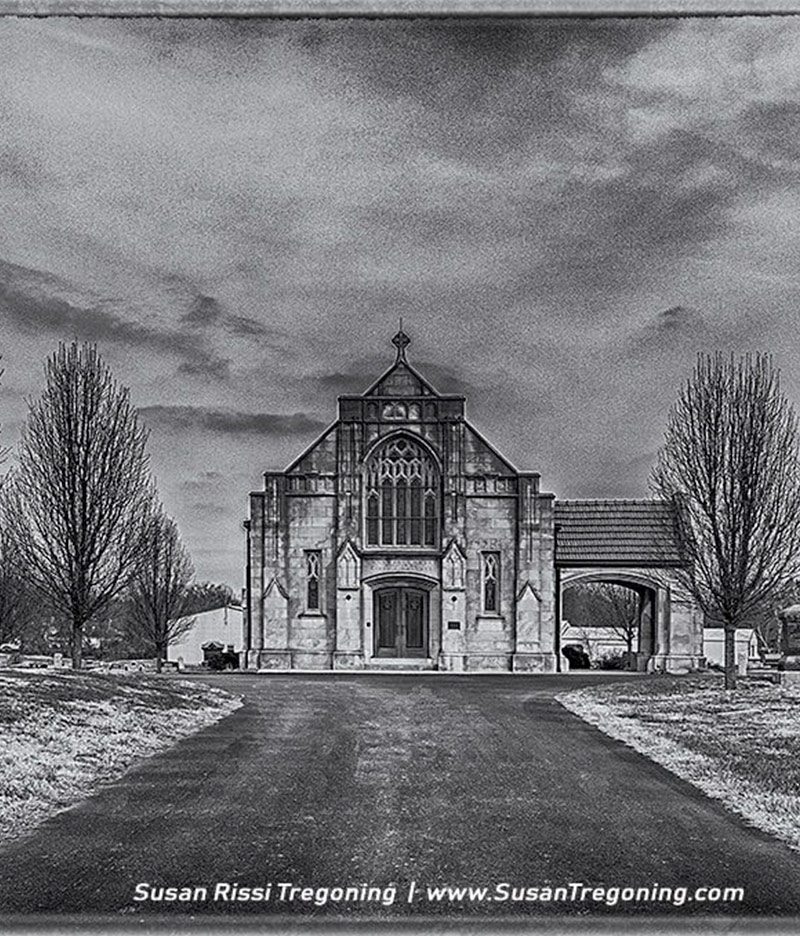 black and white image of driveway leading up to chapel
