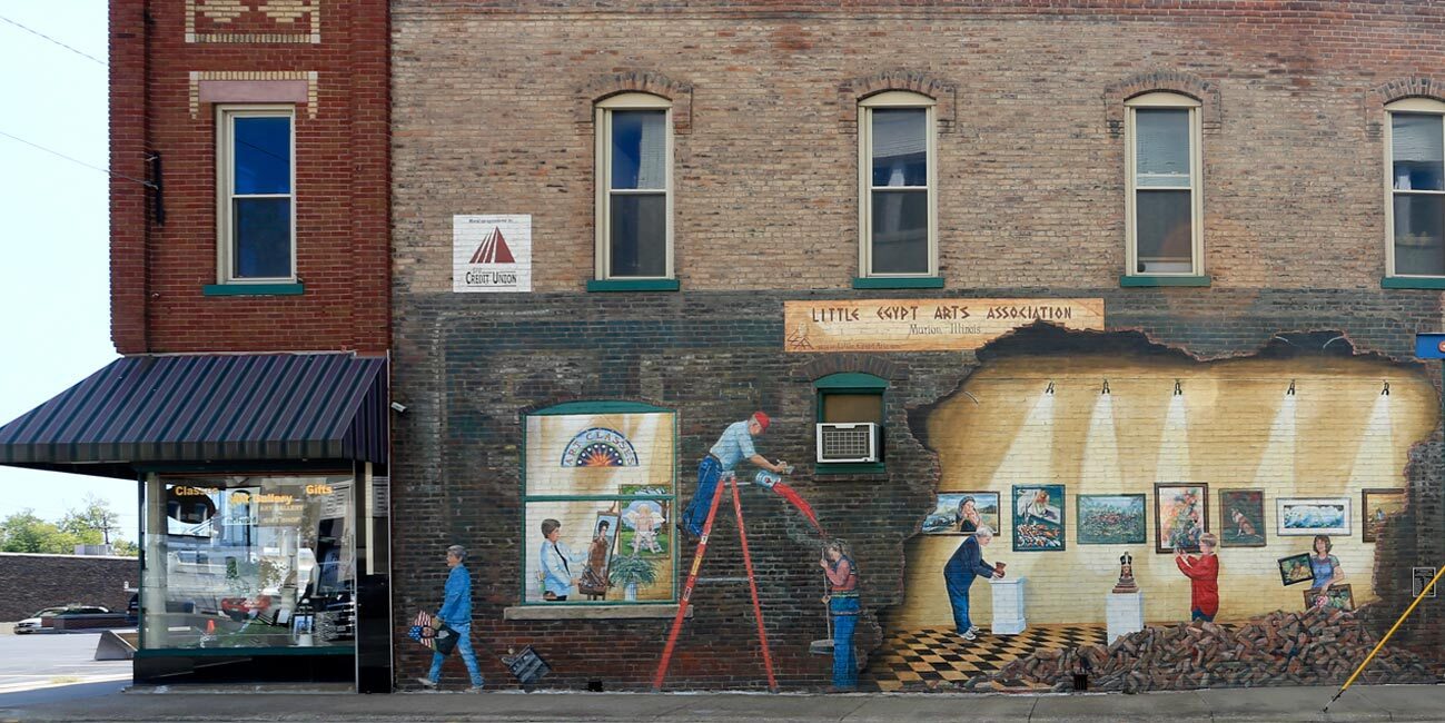 mural on brick building depicting a wrecked wall and an exposed faux interior