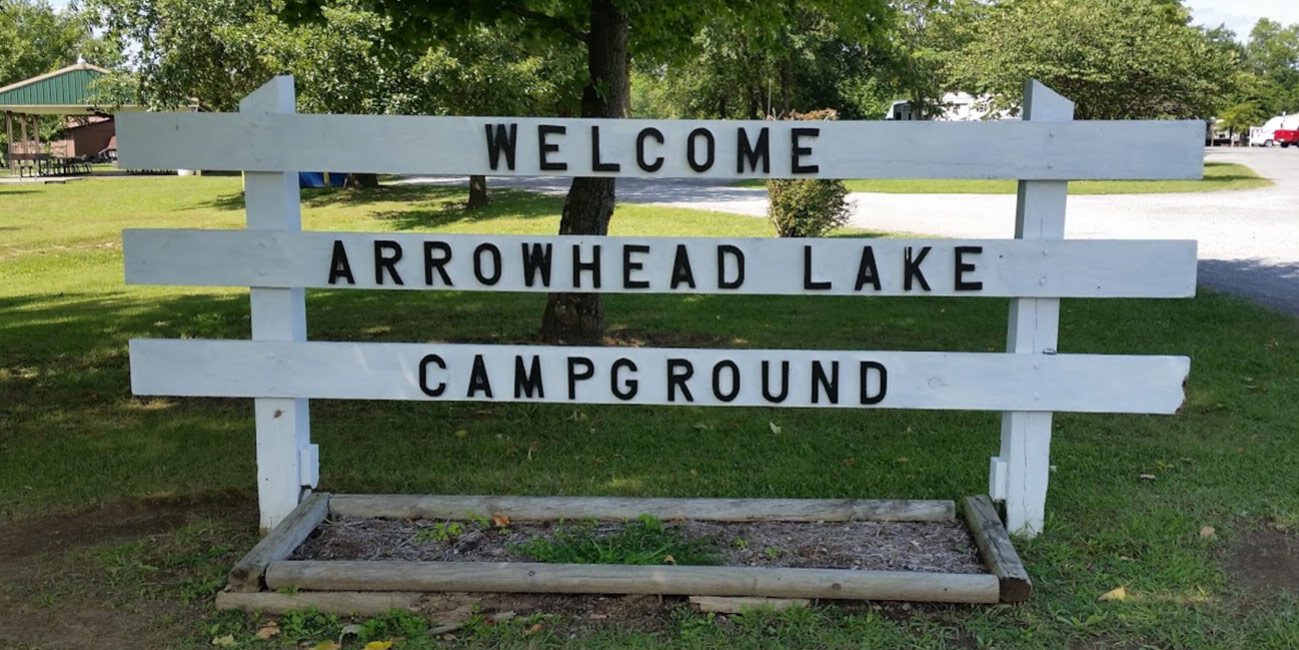 arrowhead lake campground white wooden sign