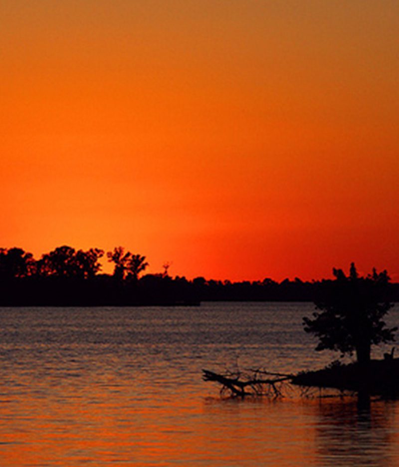 Red-orange sunset over lake at Blue Heron Marina and Campground