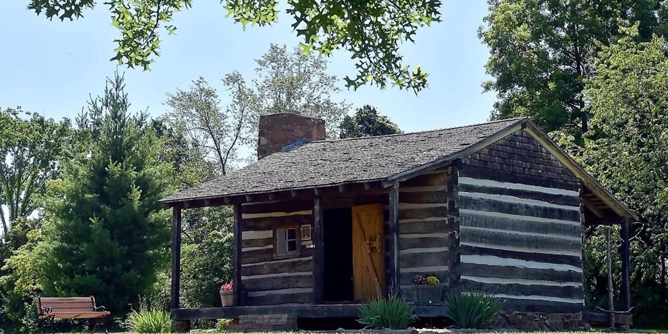exterior of small old log cabin