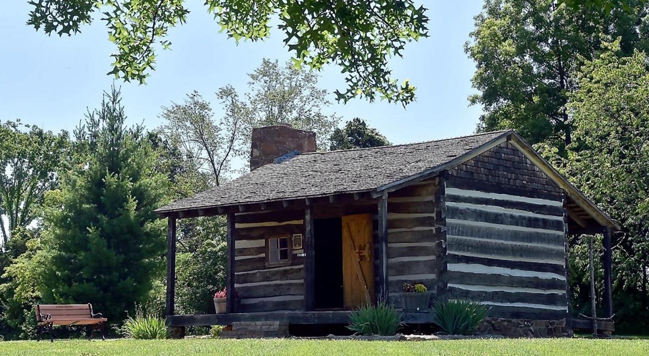 exterior of small old log cabin